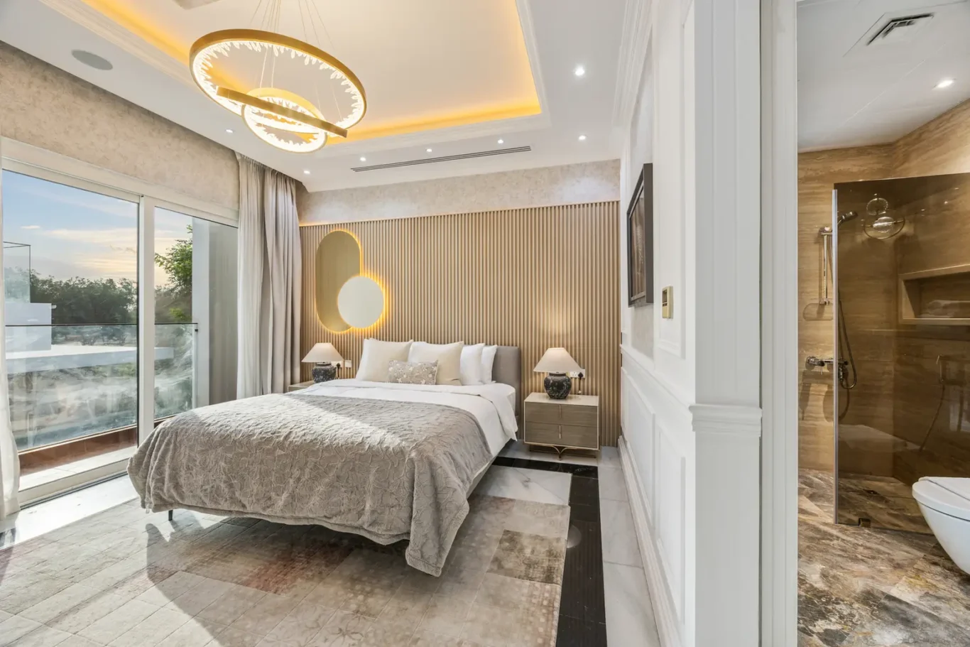 Luxurious bedroom with a large bed, neutral bedding, and warm ambient lighting from circular ceiling fixtures and wall lamps.