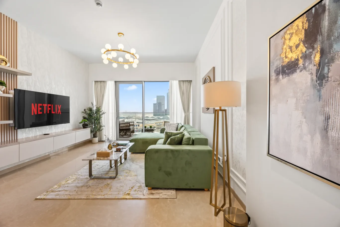 Modern living room with a green sectional sofa, wall-mounted Netflix TV, and glass coffee table facing a balcony with city view."]} }=json ఐ; (Oops) Wait format should be JSON with array. Let's provide correct. We'll provide multiple options: