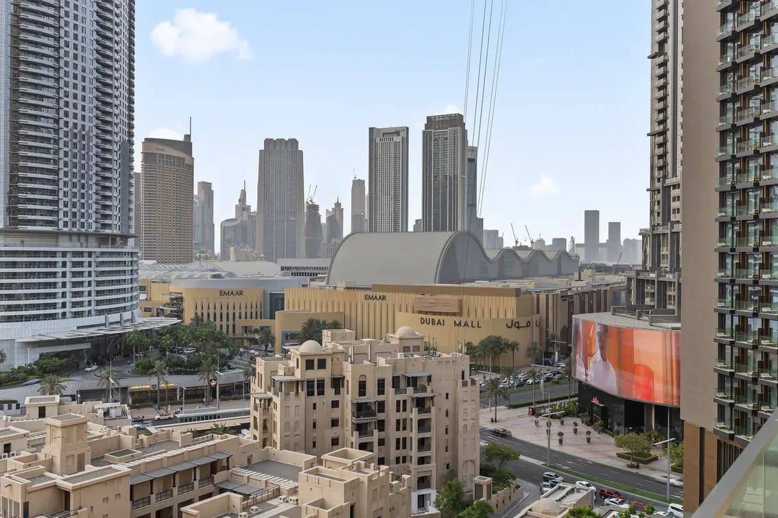 City view of Dubai with skyscrapers and the Dubai Mall in the foreground.