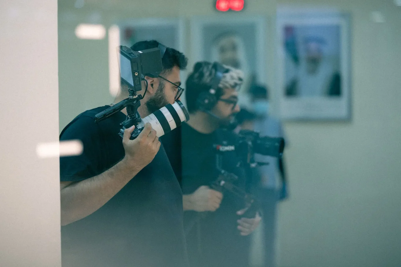 Professional photography team setting up lighting at industrial site