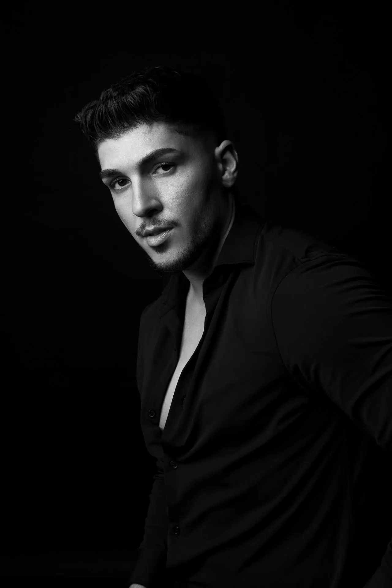 Black and white male portrait photography with dramatic lighting at a Dubai studio