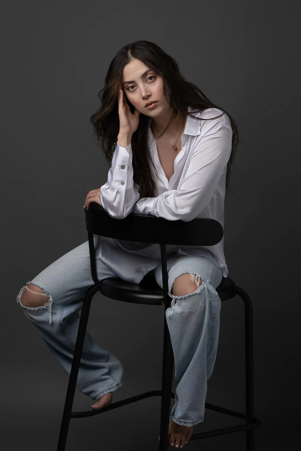 Personal photoshoot session with a woman in a seated pose at a Dubai photography studio
