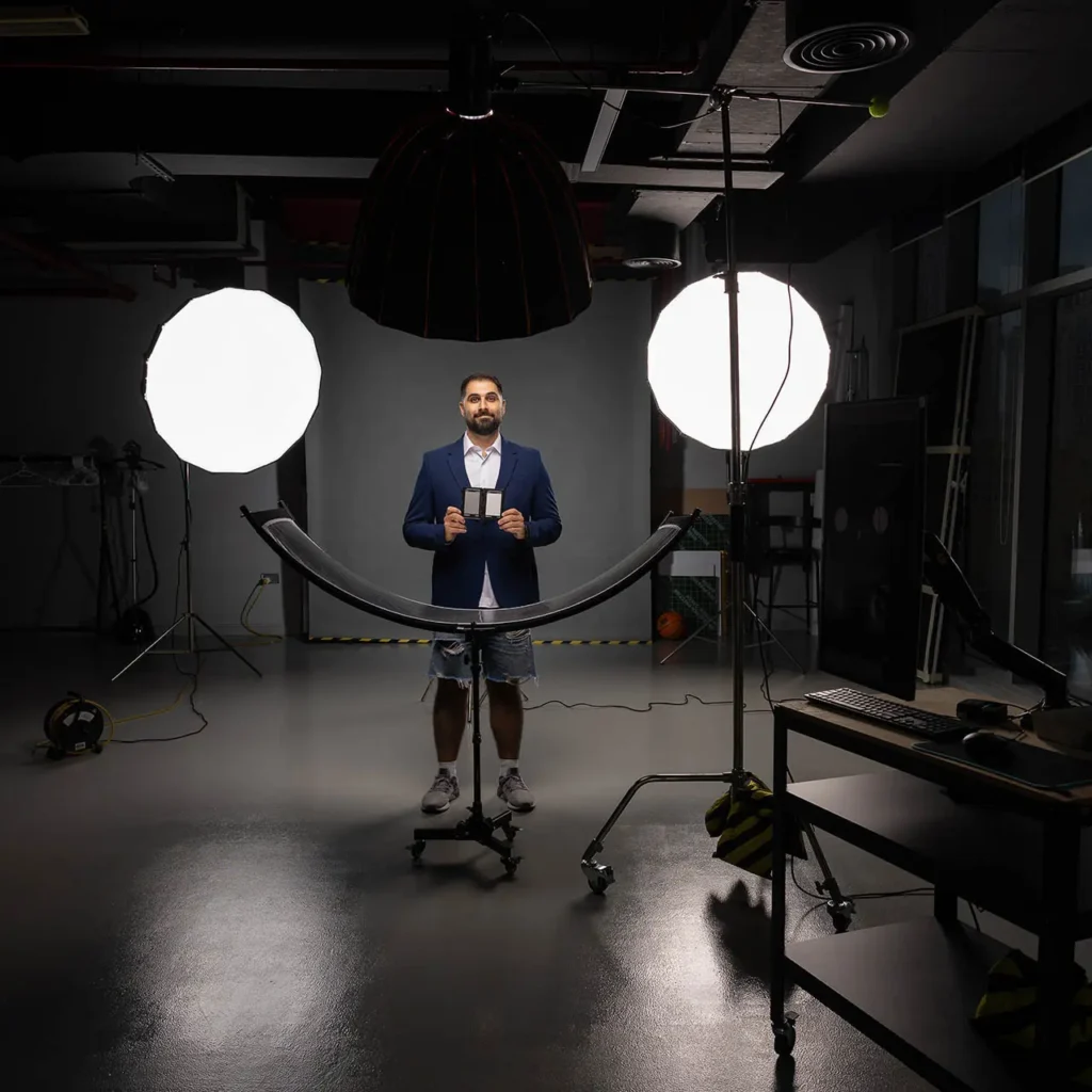 Professional photography studio with softbox lights and backdrop setup for corporate headshots in Business Bay Dubai