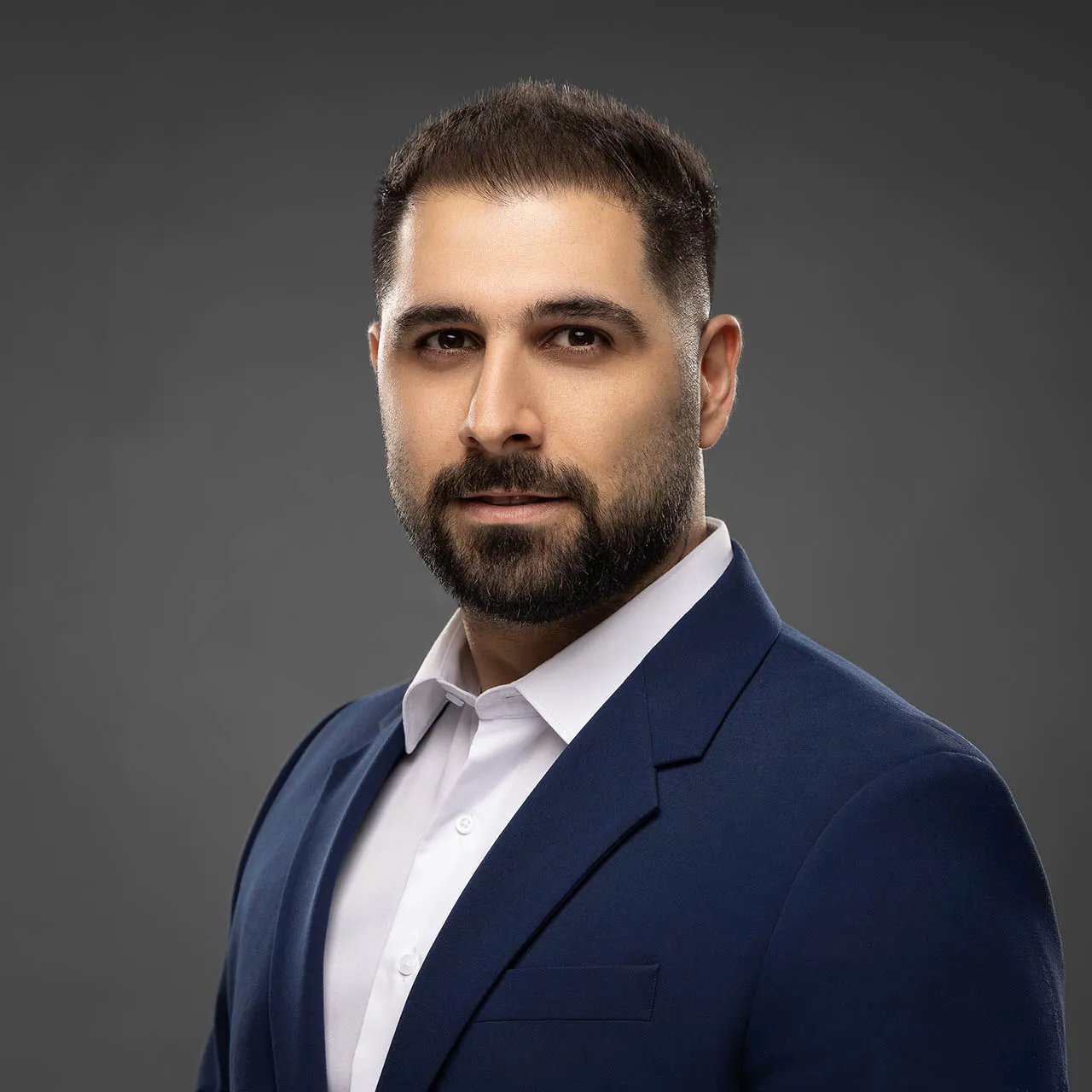 Professional business headshot showing real skin texture and depth taken at photography studio in Dubai