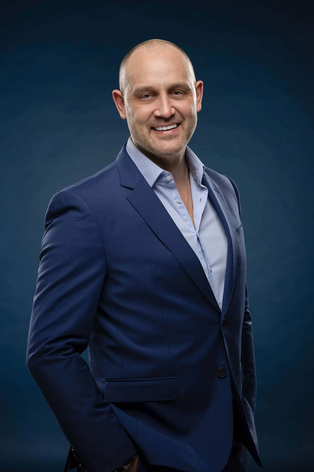 Corporate headshot of a man in a navy suit at a professional photography studio in Dubai