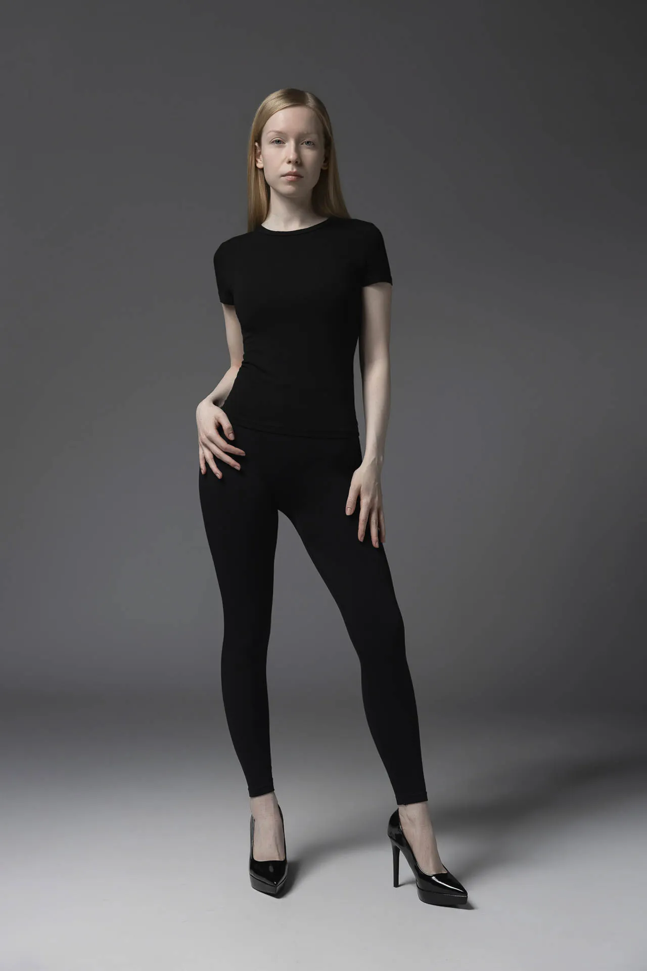 Female model in black fitted top and leggings, hand on hip — full-length Dubai modeling portfolio shot