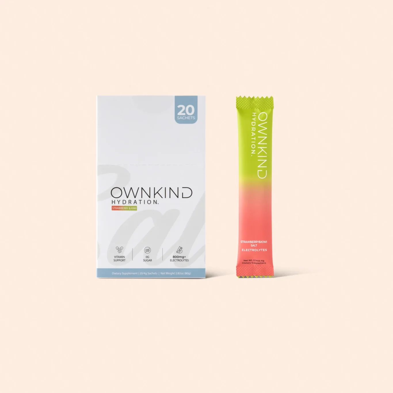 Ownkind Hydration box next to a green-pink sachet against a peach background.