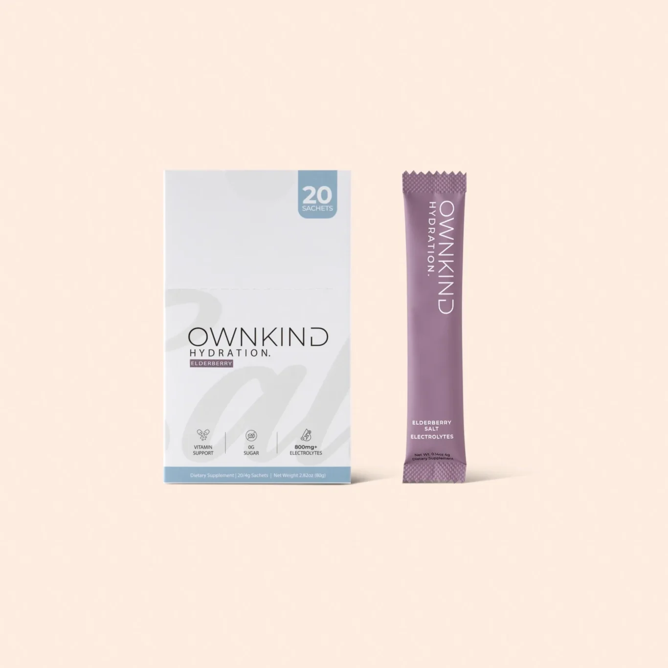 Box of OWNKIND Hydration elderberry sachets (20) next to a purple OWNKIND hydration sachet on a pale peach background, product display.