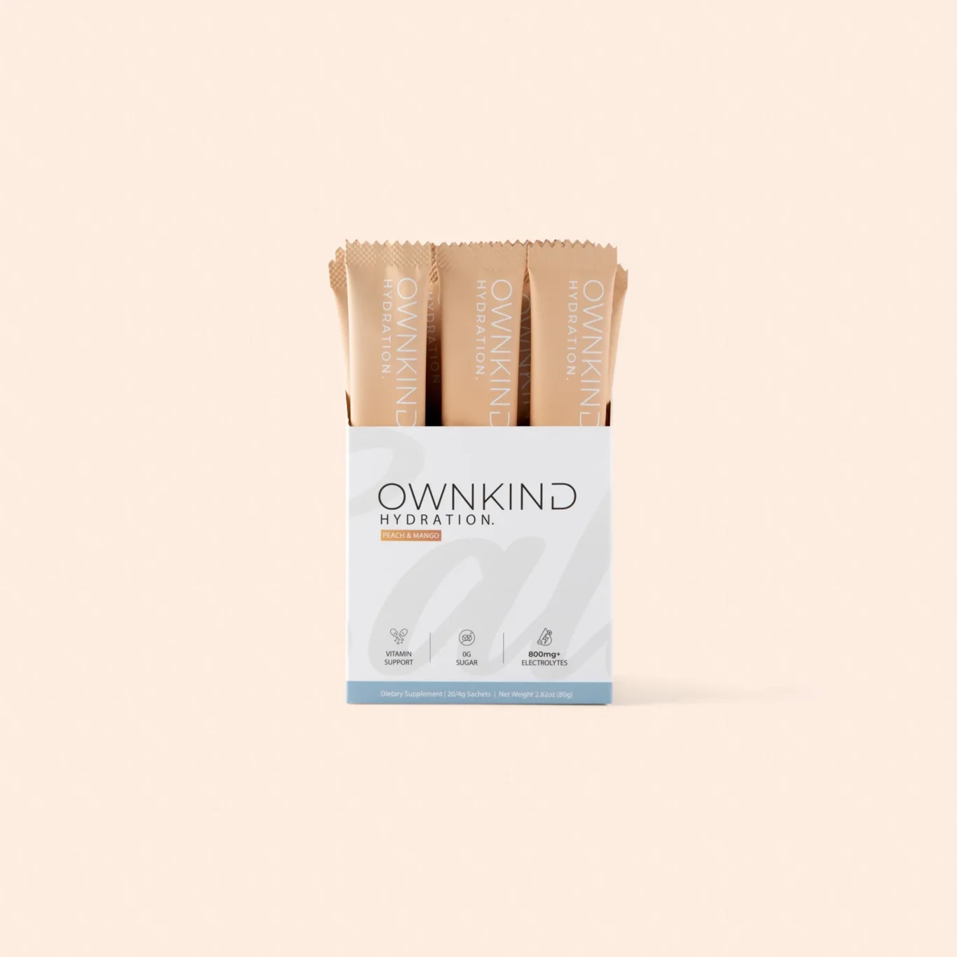 Box of OWNKIND Hydration peach & mango sachets visible inside an open package against a peach background.