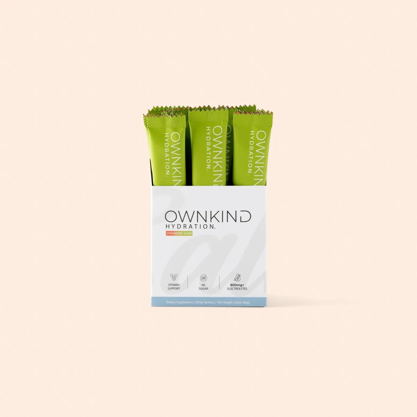 Box of OWNKIND Hydration strawberry & kiwi packets with bright green sachets visible in a white box against a peach background