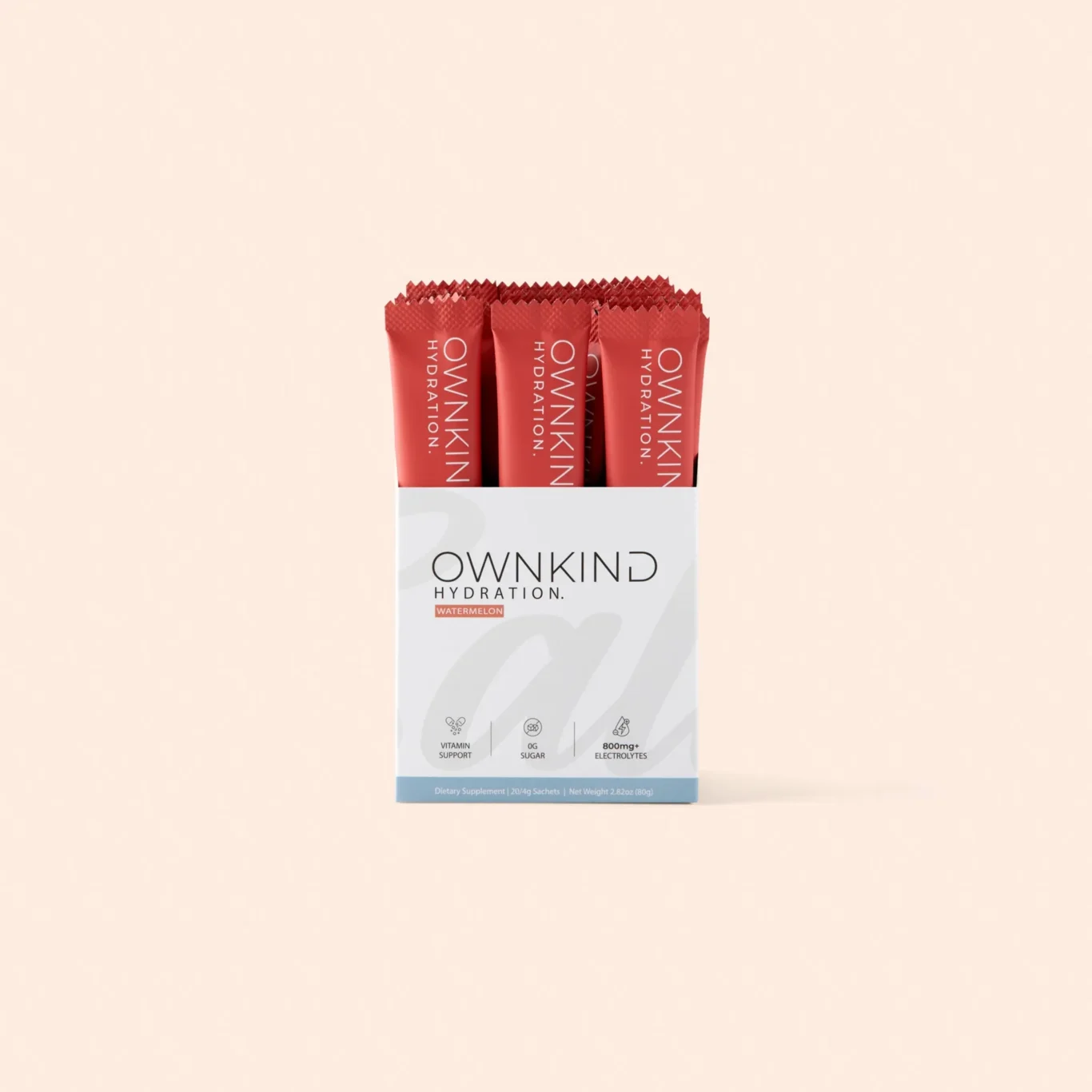 Box of OWNKIND Hydration sachets in watermelon flavor, red packets visible in an open white and gray box against a pale beige background.