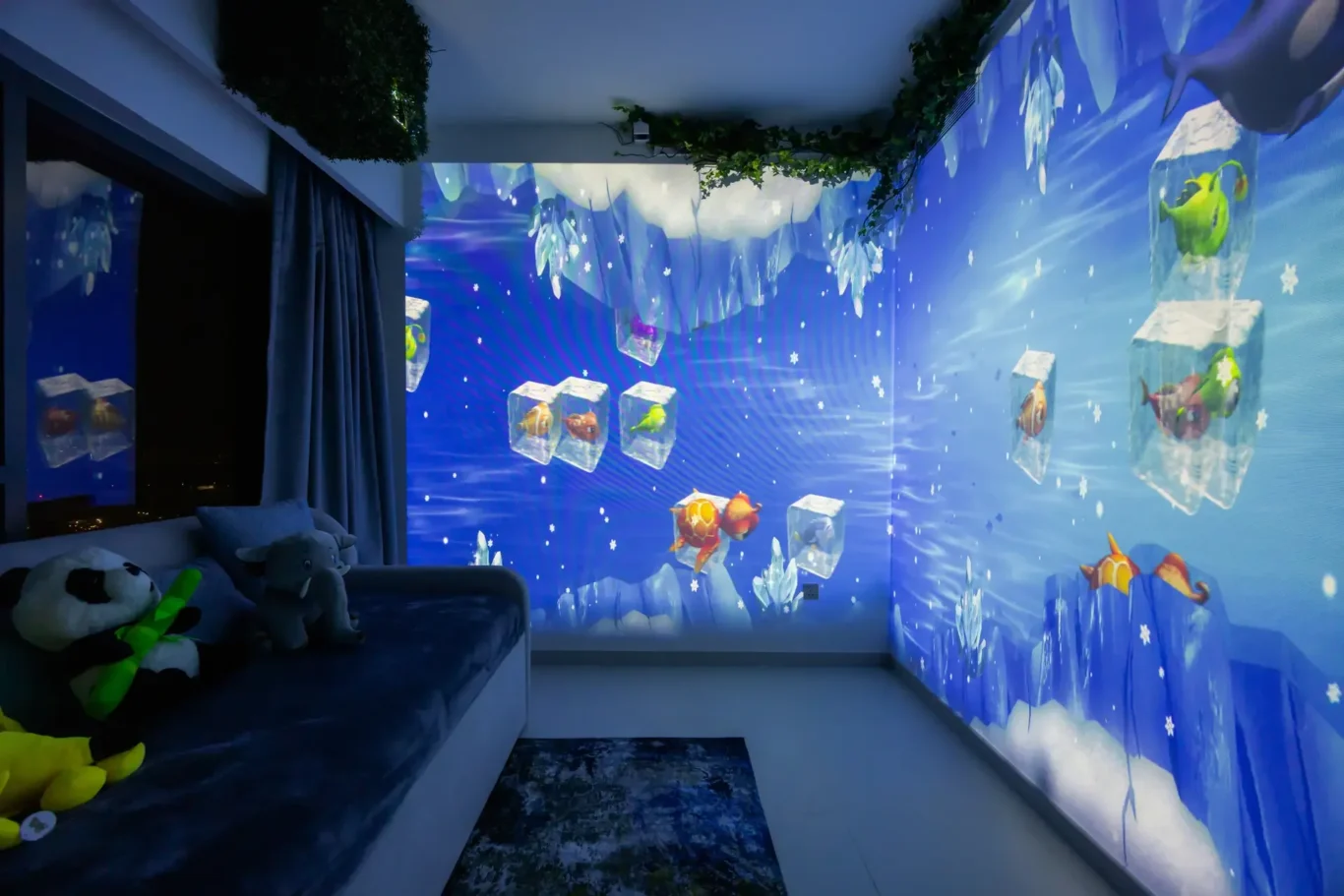 Cozy bedroom with a blue aquarium wall projection showing colorful fish frozen in ice blocks across the walls.