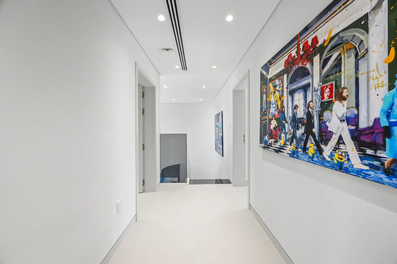 Bright white hallway with a large colorful mural along the right wall depicting a street scene with musicians and figures.