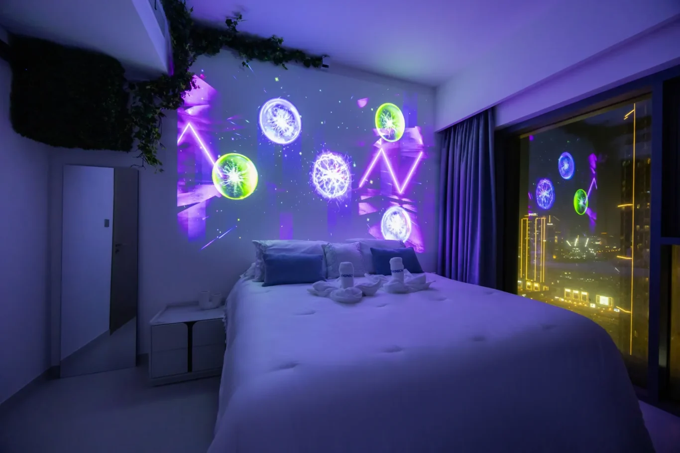 Hotel room at night with a bed and wall-projected neon art: glowing purple zigzags and bright orbs filling the wall behind the bed