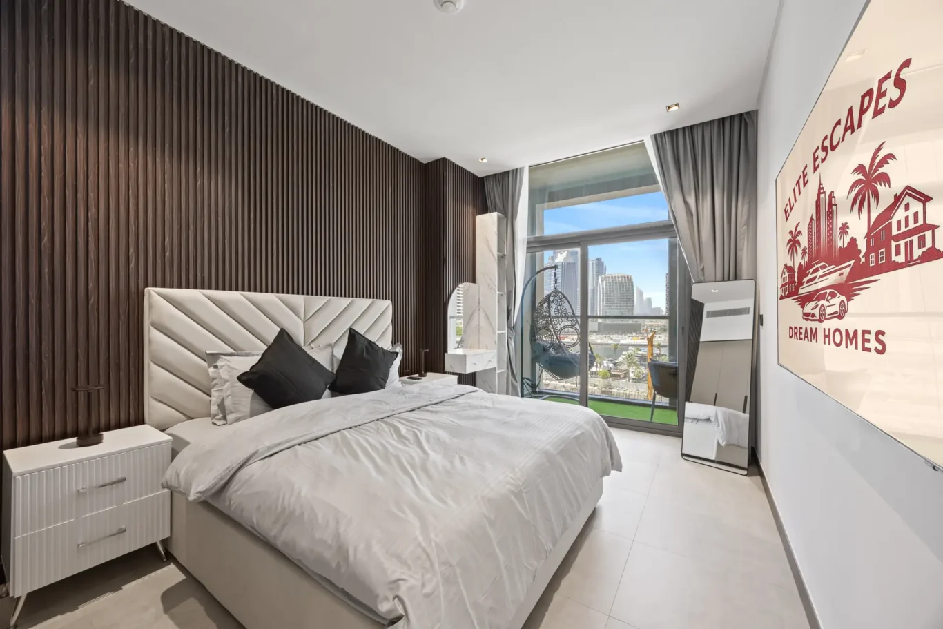 Contemporary hotel bedroom with a white tufted headboard, gray bedding, and a dark wood slat accent wall overlooking a city skyline through large windows.