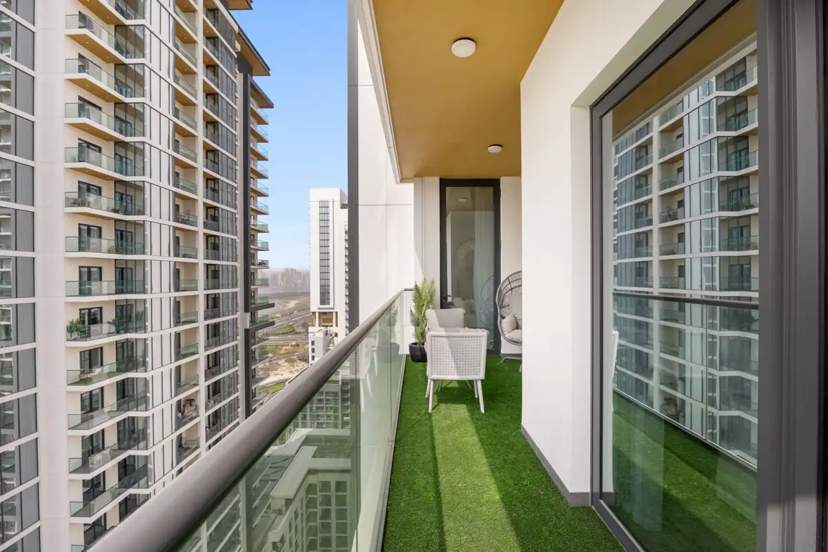 Balcony with seating and Downtown Dubai skyline, Airbnb at Crest Grande, Sobha Hartland, daylight