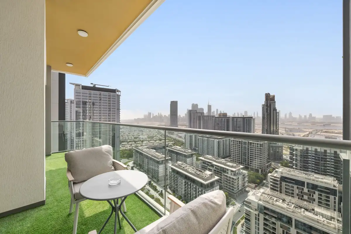 Balcony with seating and Downtown Dubai skyline, Airbnb at Crest Grande, Sobha Hartland, daylight