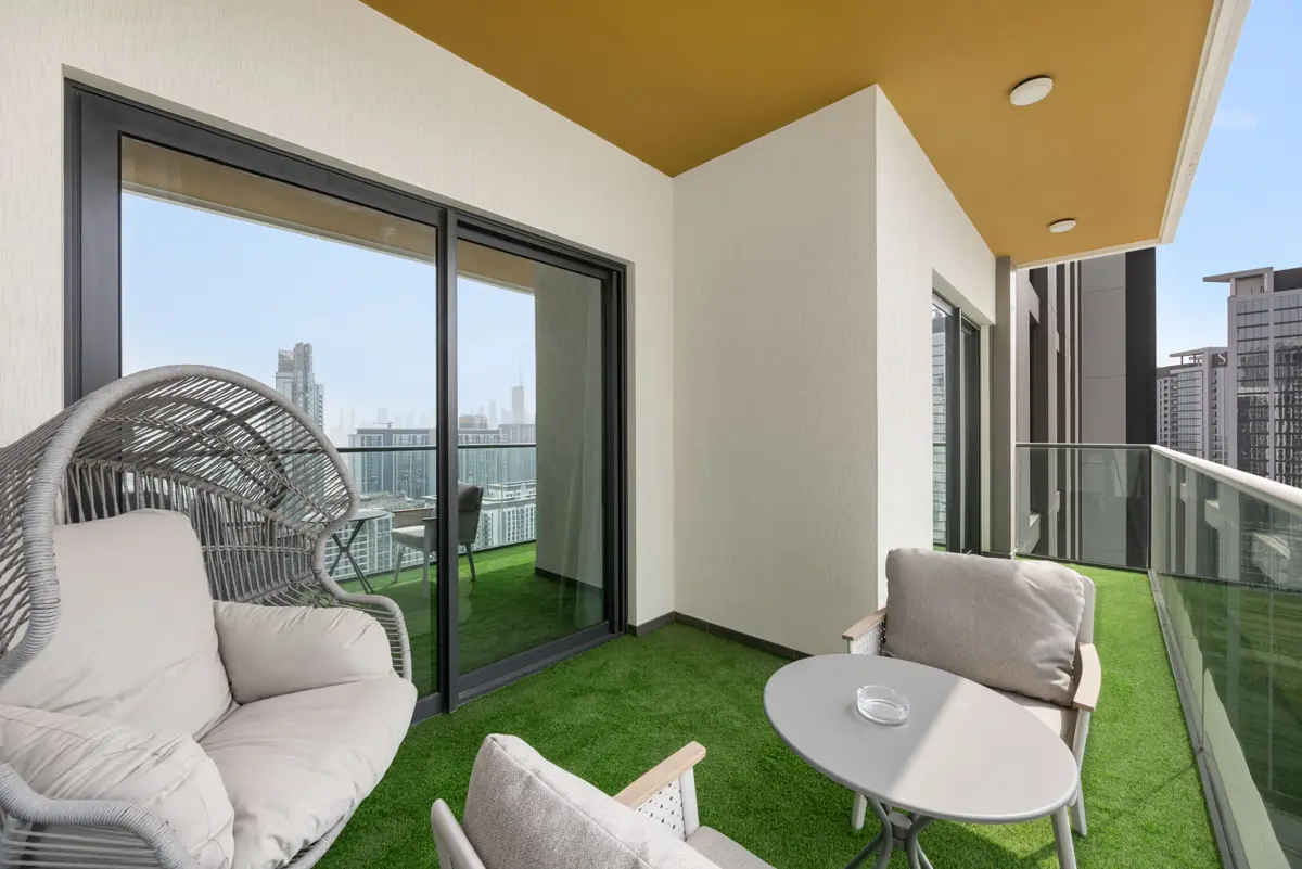 Balcony with seating and Downtown Dubai skyline, Airbnb at Crest Grande, Sobha Hartland, daylight