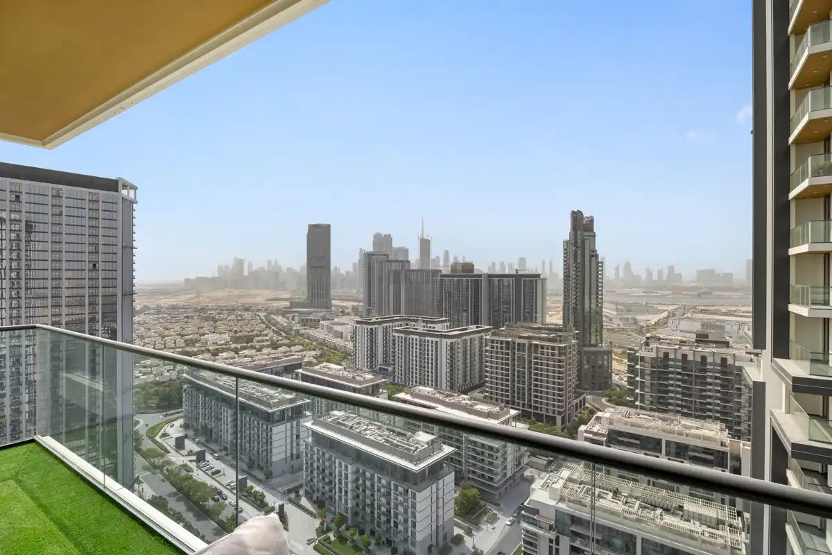Balcony with seating and Downtown Dubai skyline, Airbnb at Crest Grande, Sobha Hartland, daylight