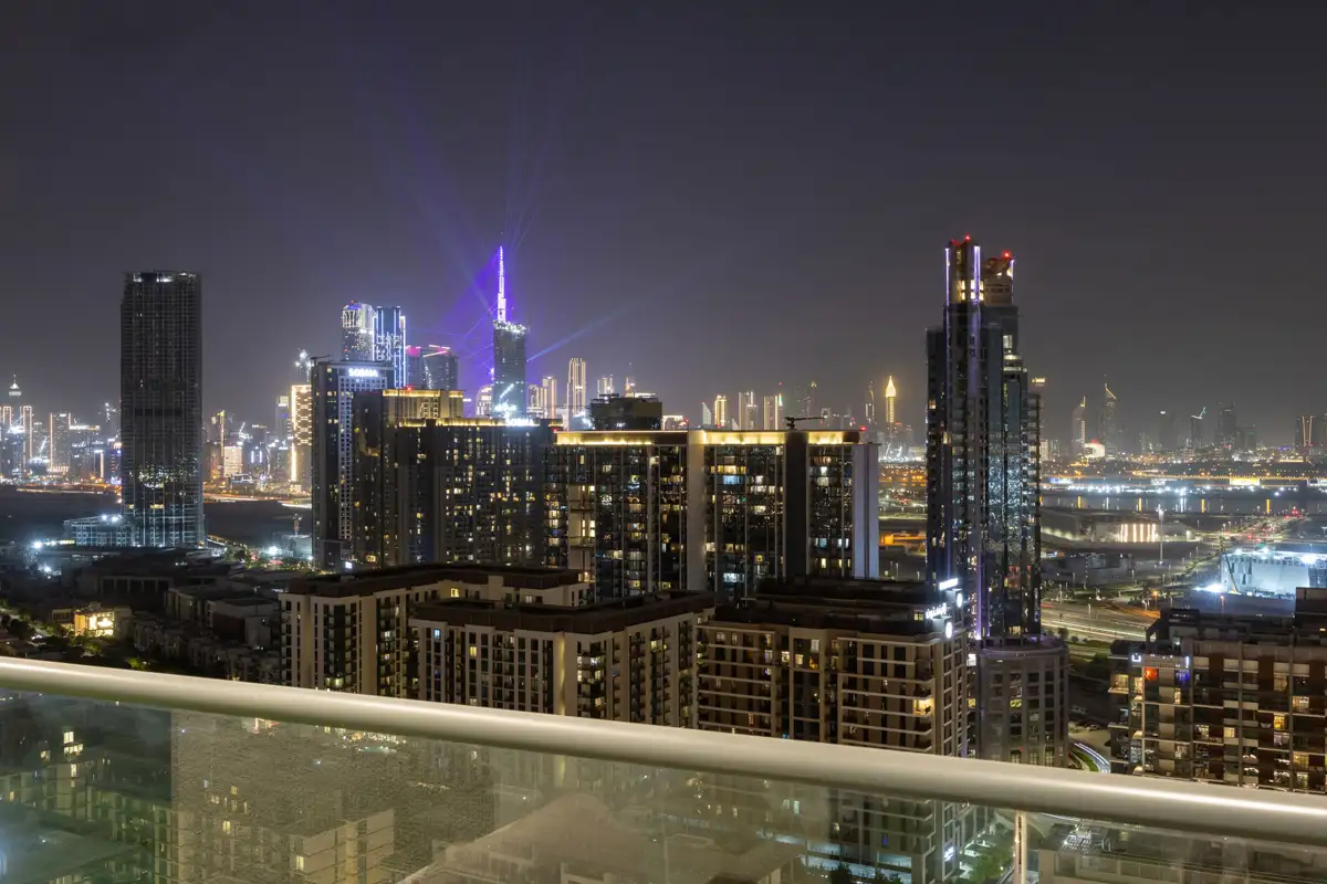Balcony at night with the Burj Khalifa light show, Airbnb at Crest Grande, Sobha Hartland, Dubai