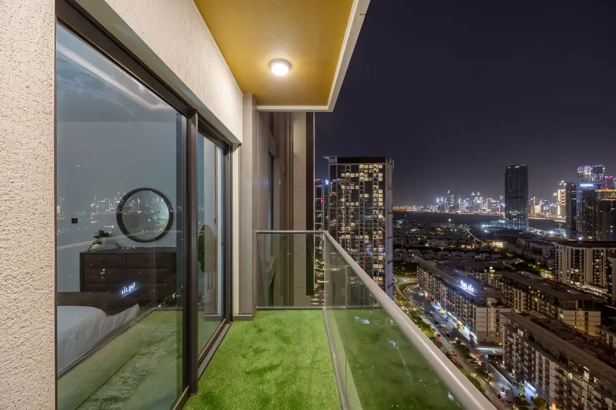 Balcony at night with the Burj Khalifa light show, Airbnb at Crest Grande, Sobha Hartland, Dubai