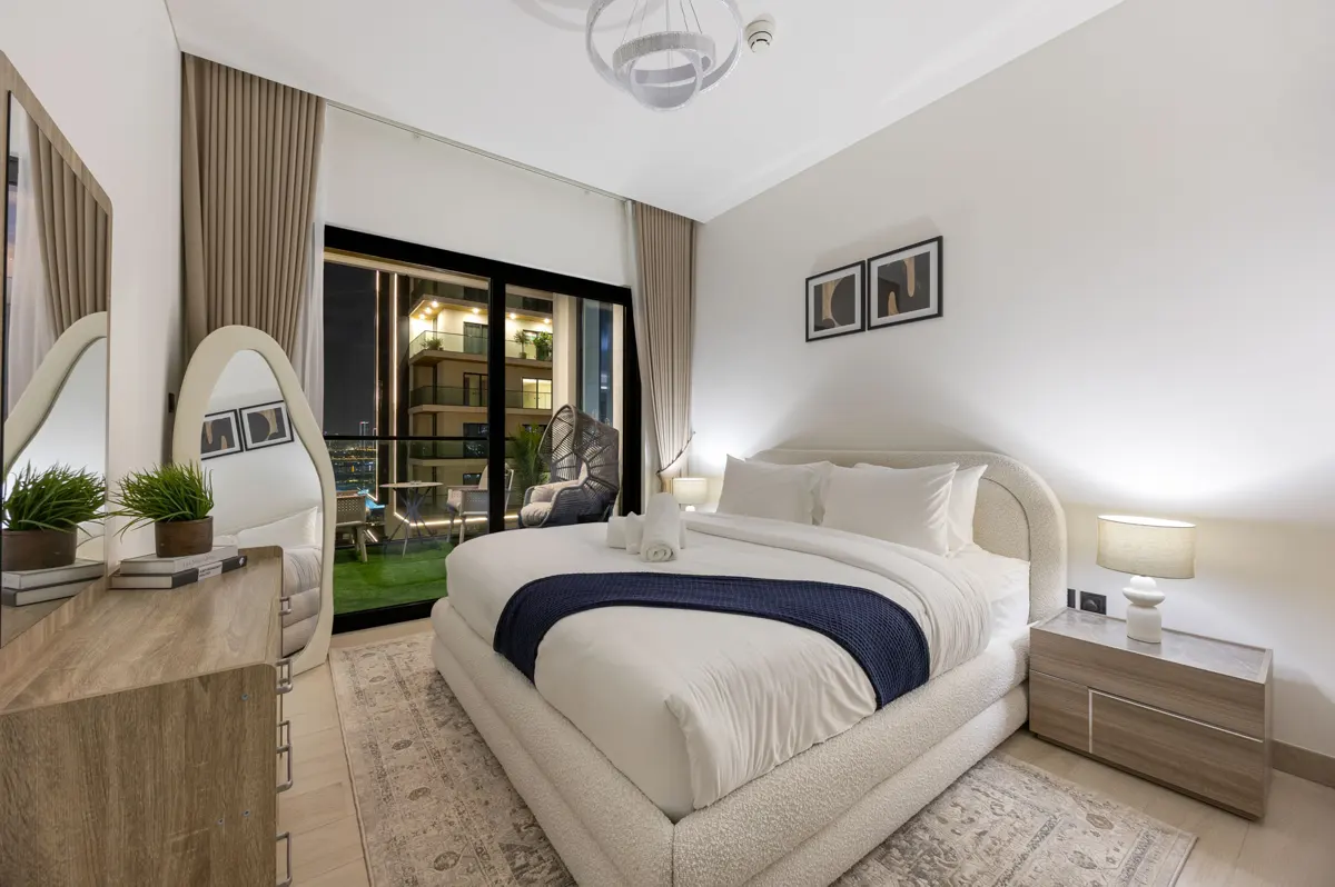 King bedroom and balcony at night, Airbnb at Crest Grande, Sobha Hartland, Dubai