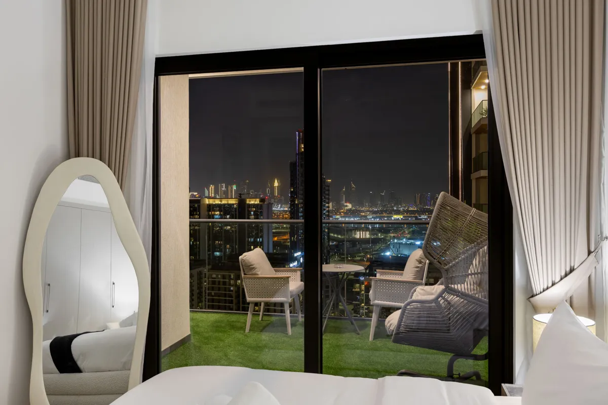 King bedroom and balcony at night, Airbnb at Crest Grande, Sobha Hartland, Dubai