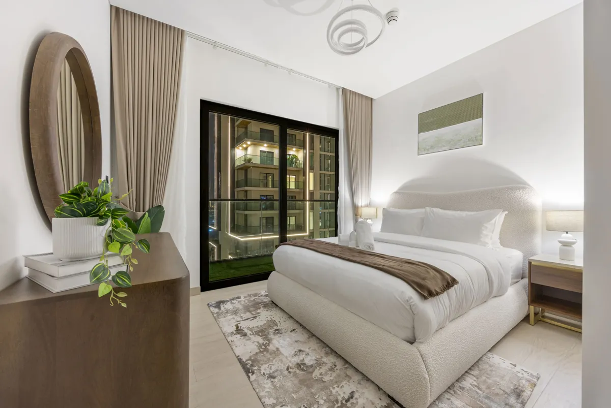 Queen bedroom at night with Downtown Dubai lights, Airbnb at Crest Grande, Sobha Hartland