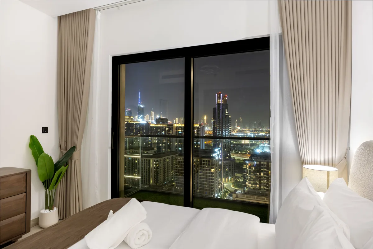 Queen bedroom at night with Downtown Dubai lights, Airbnb at Crest Grande, Sobha Hartland