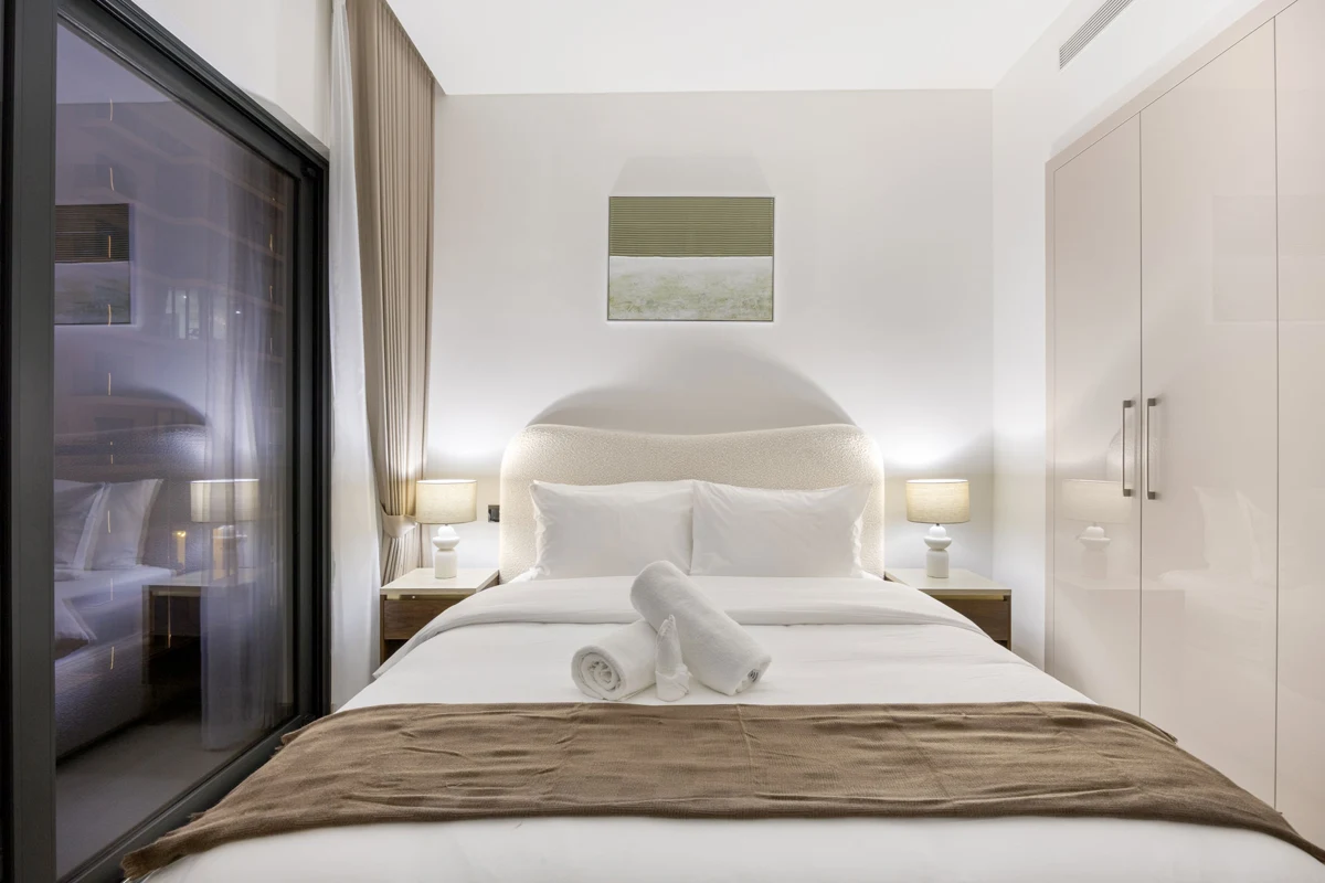 Queen bedroom at night with Downtown Dubai lights, Airbnb at Crest Grande, Sobha Hartland