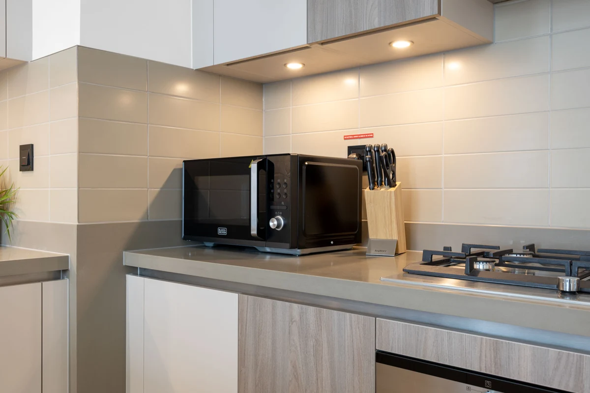 Airbnb kitchen photography at Crest Grande, Sobha Hartland, Dubai: appliances and counters in daylight