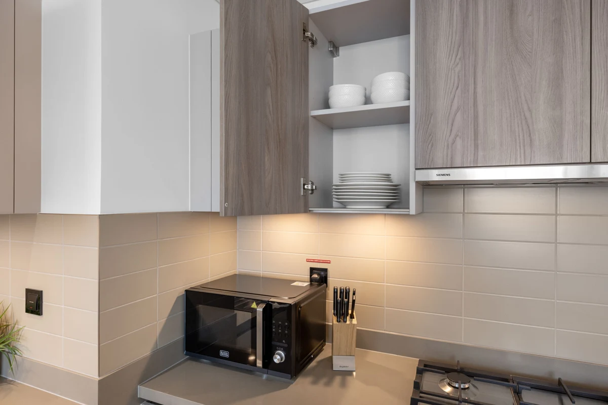 Kitchen detail photo for Airbnb listing: cupboards, dishwasher and cutlery, Crest Grande, Sobha Hartland