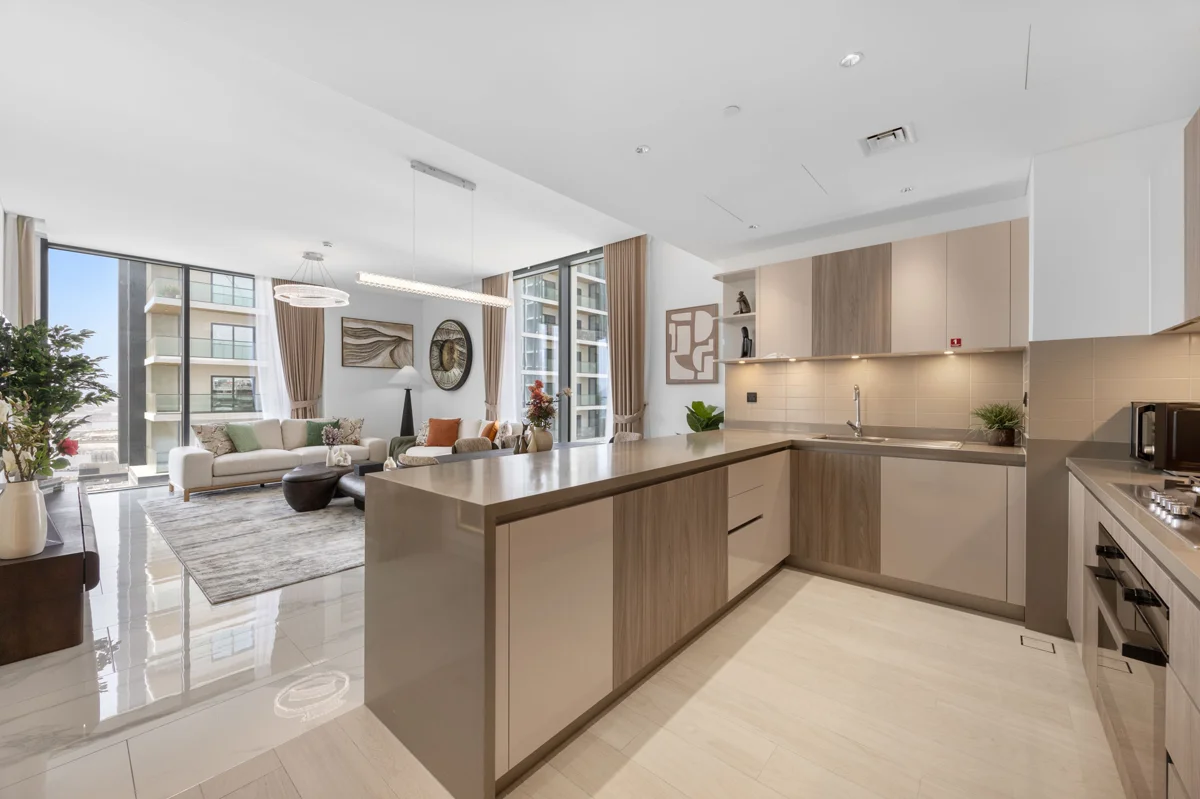 Open-plan kitchen island and dining table of a 3-bedroom Airbnb at Crest Grande, Sobha Hartland, daylight