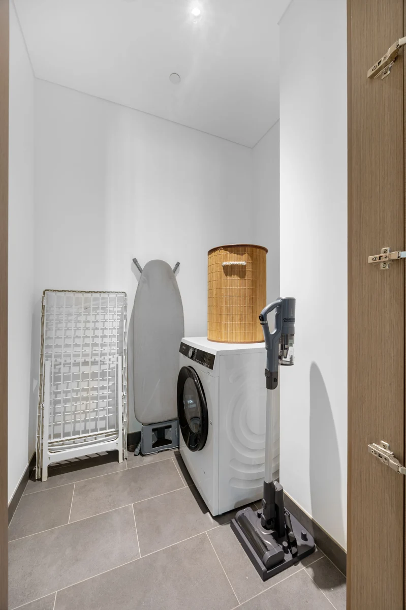 Laundry room with washer-dryer, Airbnb apartment at Crest Grande, Sobha Hartland