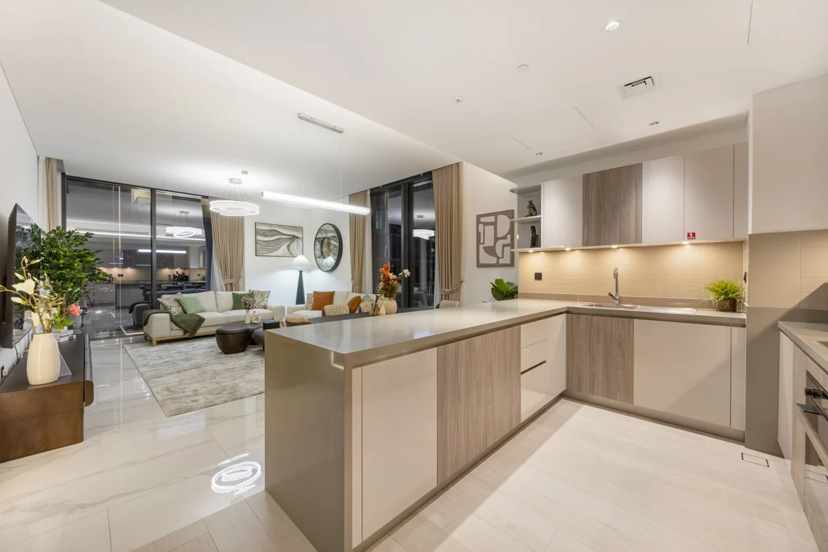 Living room, kitchen and dining at night with city lights, Airbnb at Crest Grande, Sobha Hartland