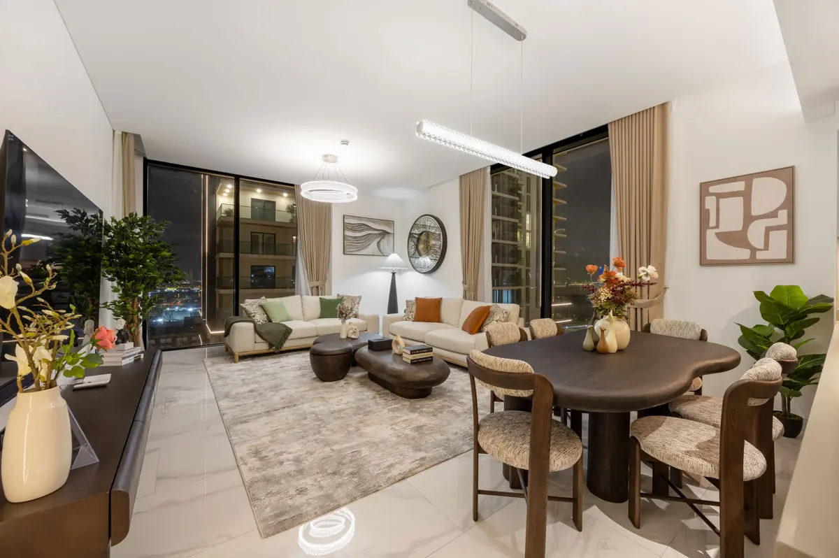 Living room, kitchen and dining at night with city lights, Airbnb at Crest Grande, Sobha Hartland