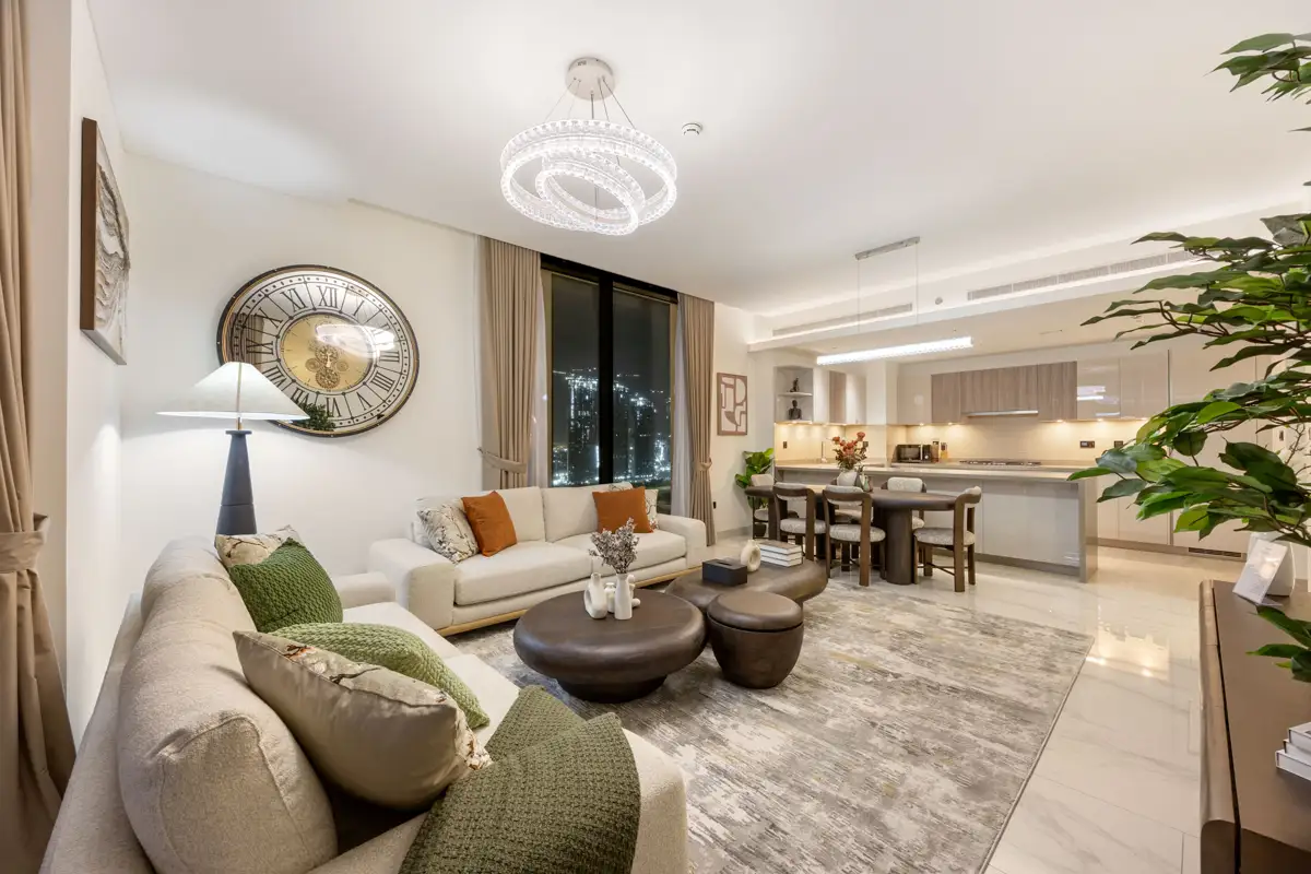 Living room, kitchen and dining at night with city lights, Airbnb at Crest Grande, Sobha Hartland