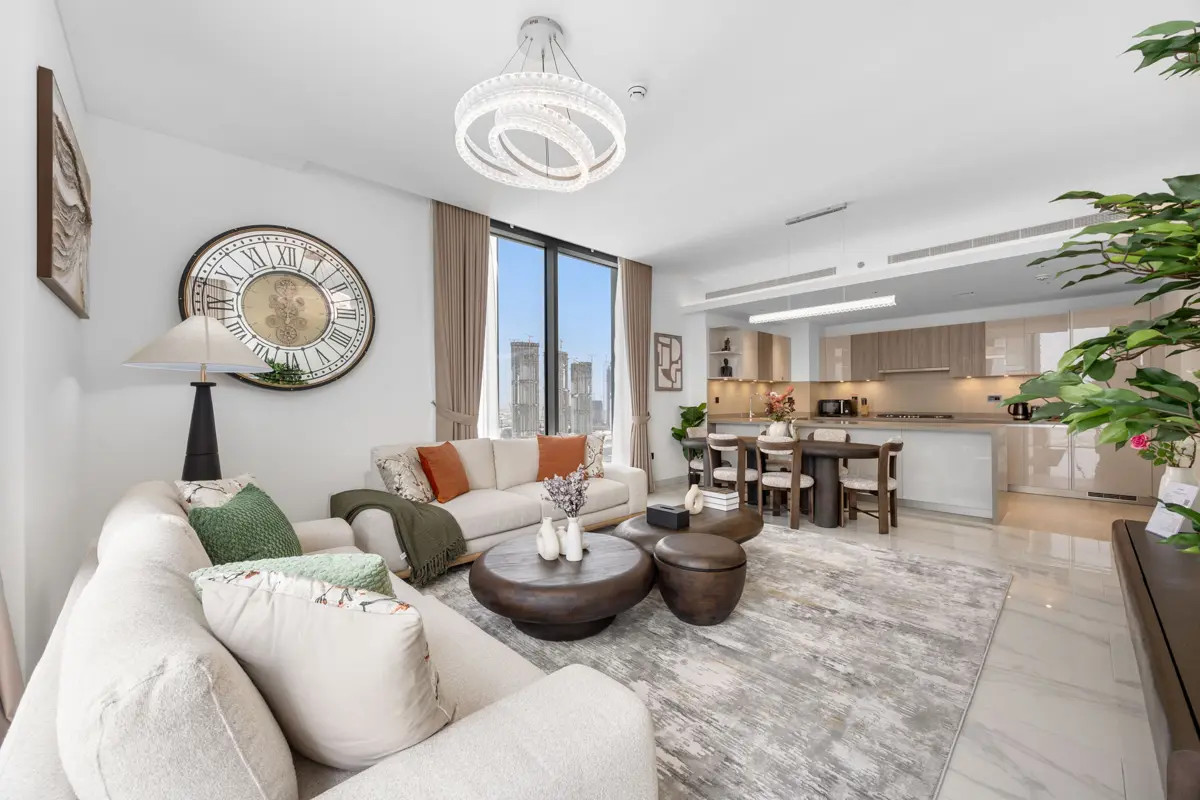 Living room of a 3-bedroom Airbnb at Crest Grande, Sobha Hartland with Burj Khalifa skyline view, daylight