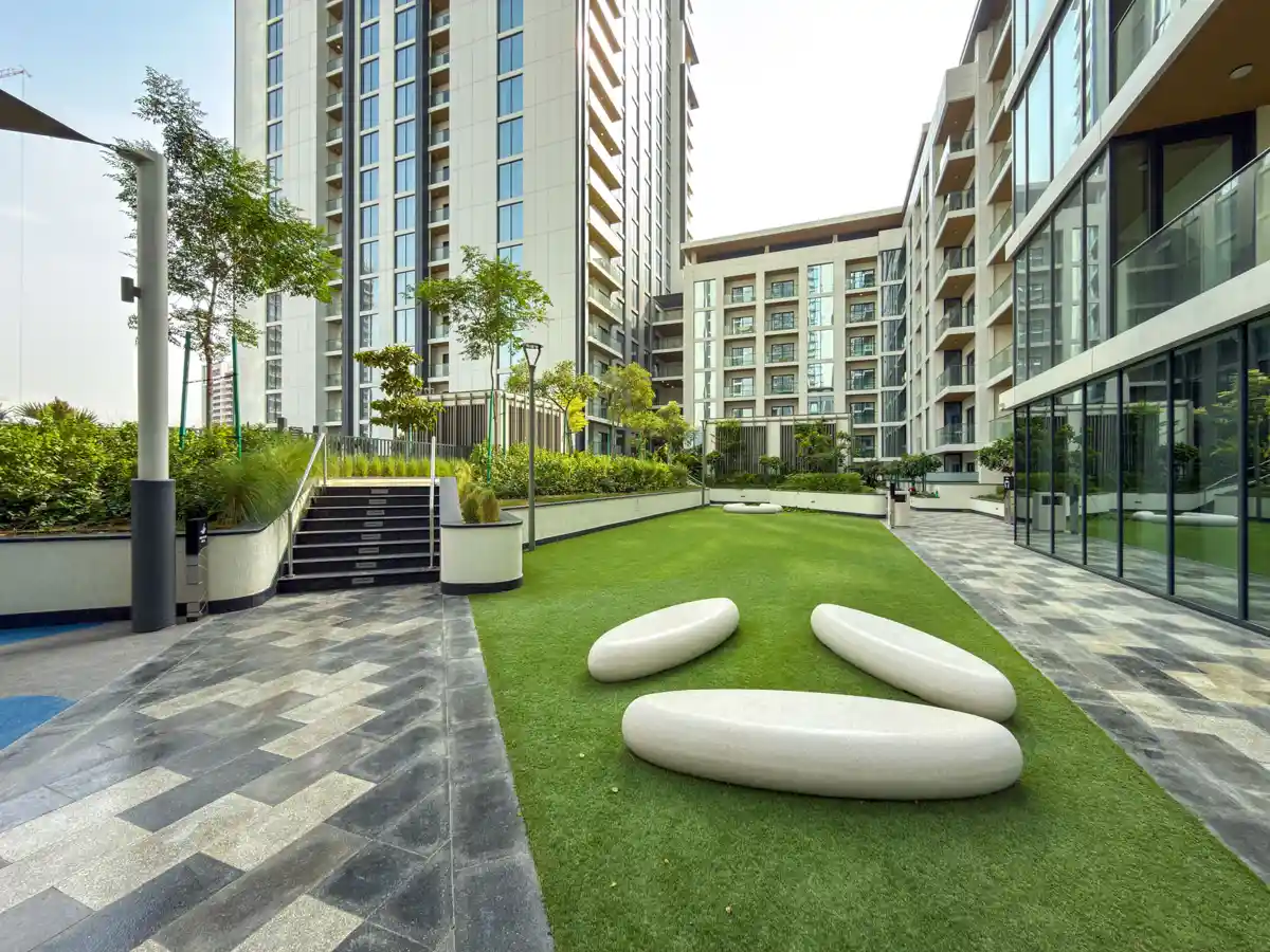 Podium amenities at Crest Grande, Sobha Hartland: outdoor gym, kids playground and lawn, Airbnb photography