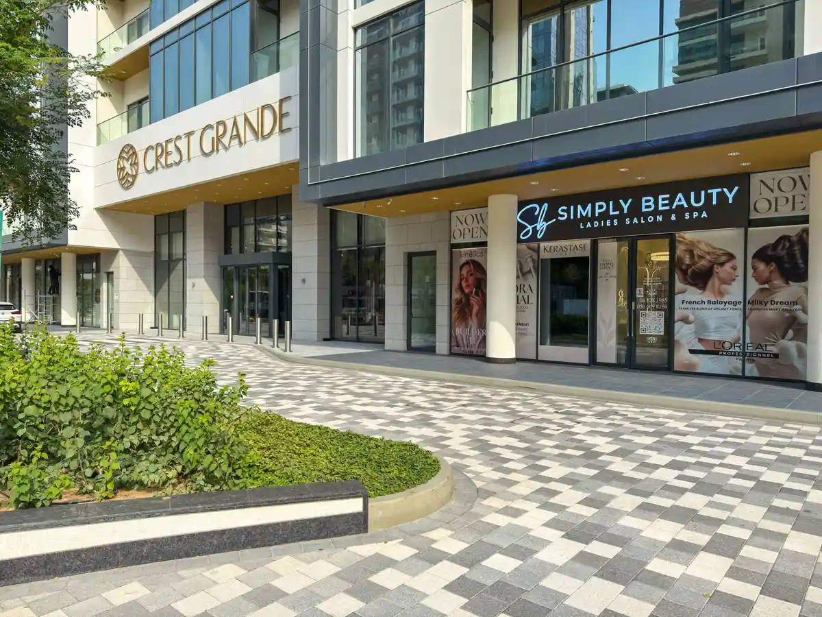 Retail street at Crest Grande, Sobha Hartland: supermarket, pharmacy, salon and cafe within the building, daylight
