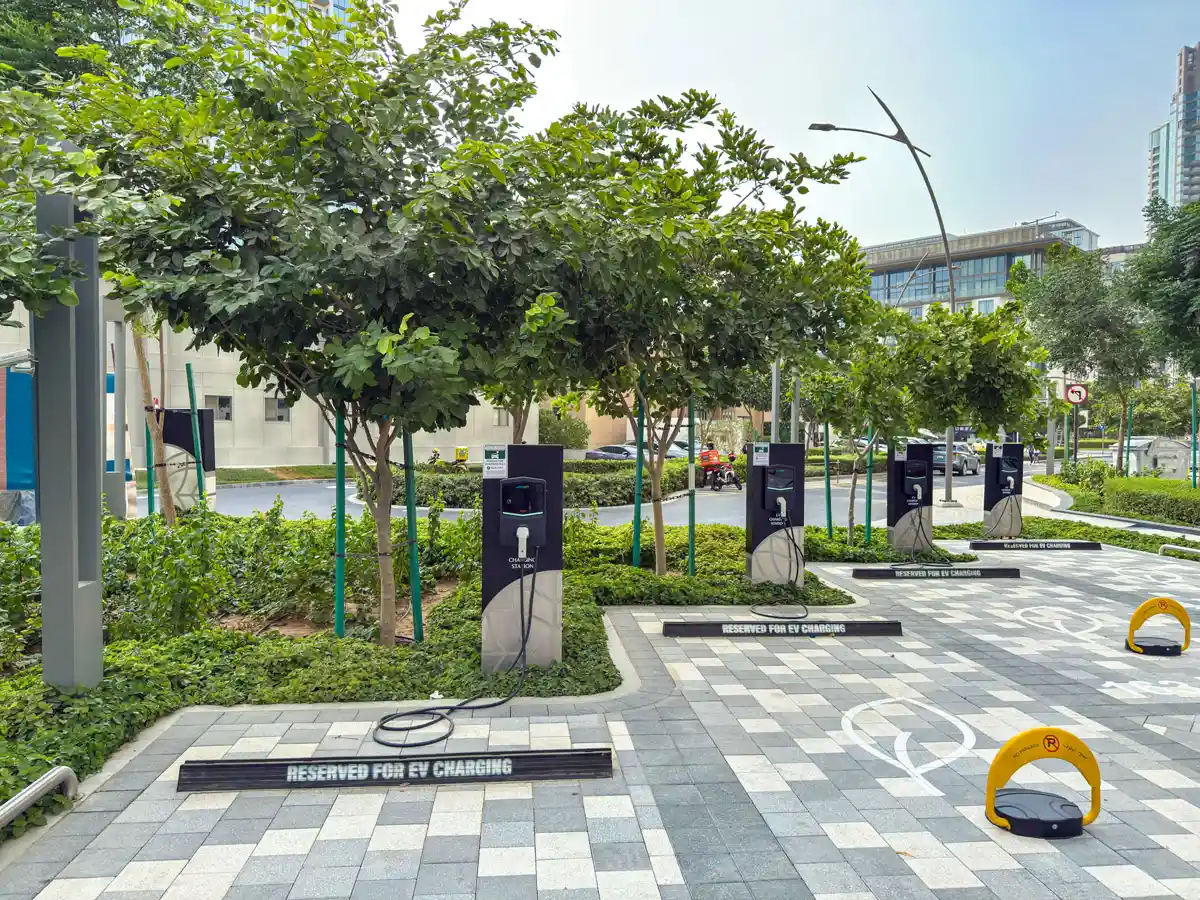 Retail street at Crest Grande, Sobha Hartland: supermarket, pharmacy, salon and cafe within the building, daylight