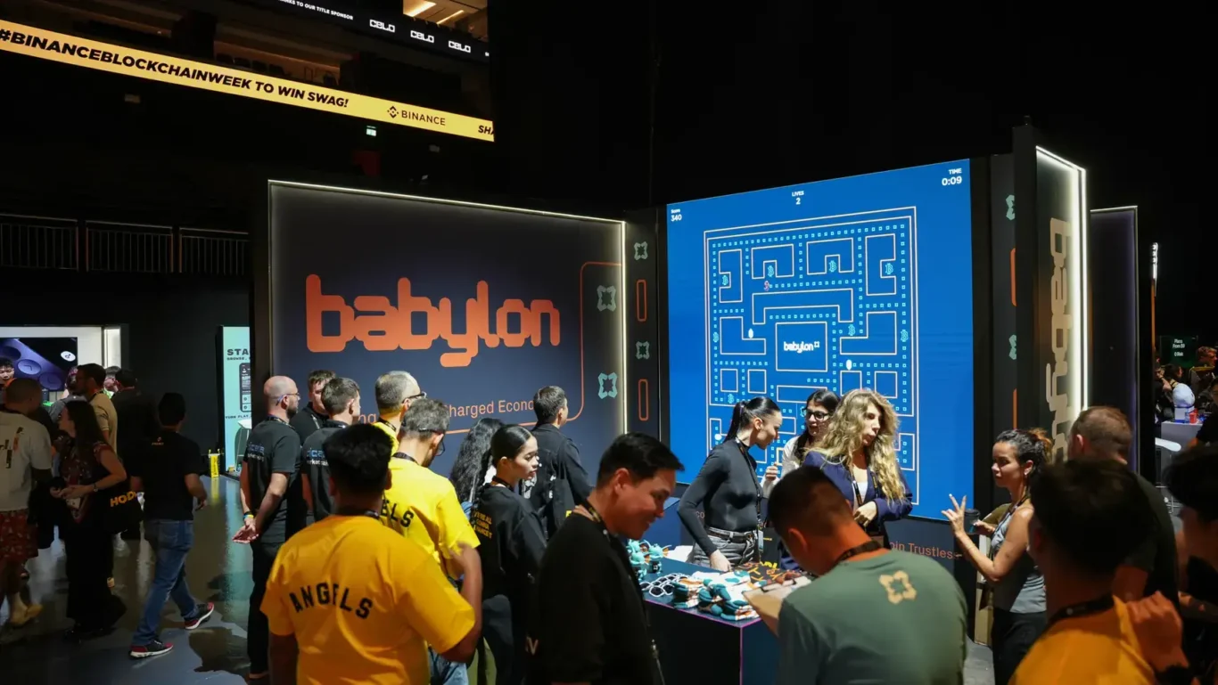 Visitors crowding the Babylon booth on the exhibition floor. Photographed by MRPS for Eventflare at Binance Blockchain Week 2025, Coca-Cola Arena, Dubai.