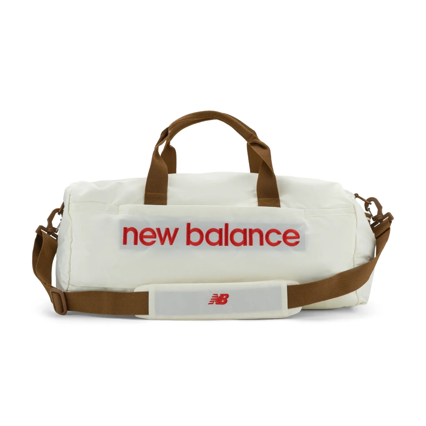 White New Balance duffel bag with red logo and brown straps, front view on white. E-commerce product photography for New Balance by MRPS in Dubai.