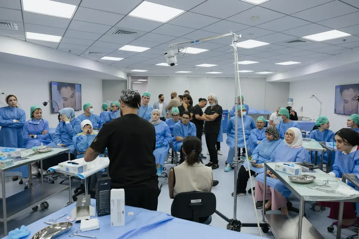 Wide view of the anatomy lab during the hands-on session, with doctors at every station. Event photography by MRPS at the Promoitalia Cadaver Lab medical anatomy course in Dubai.