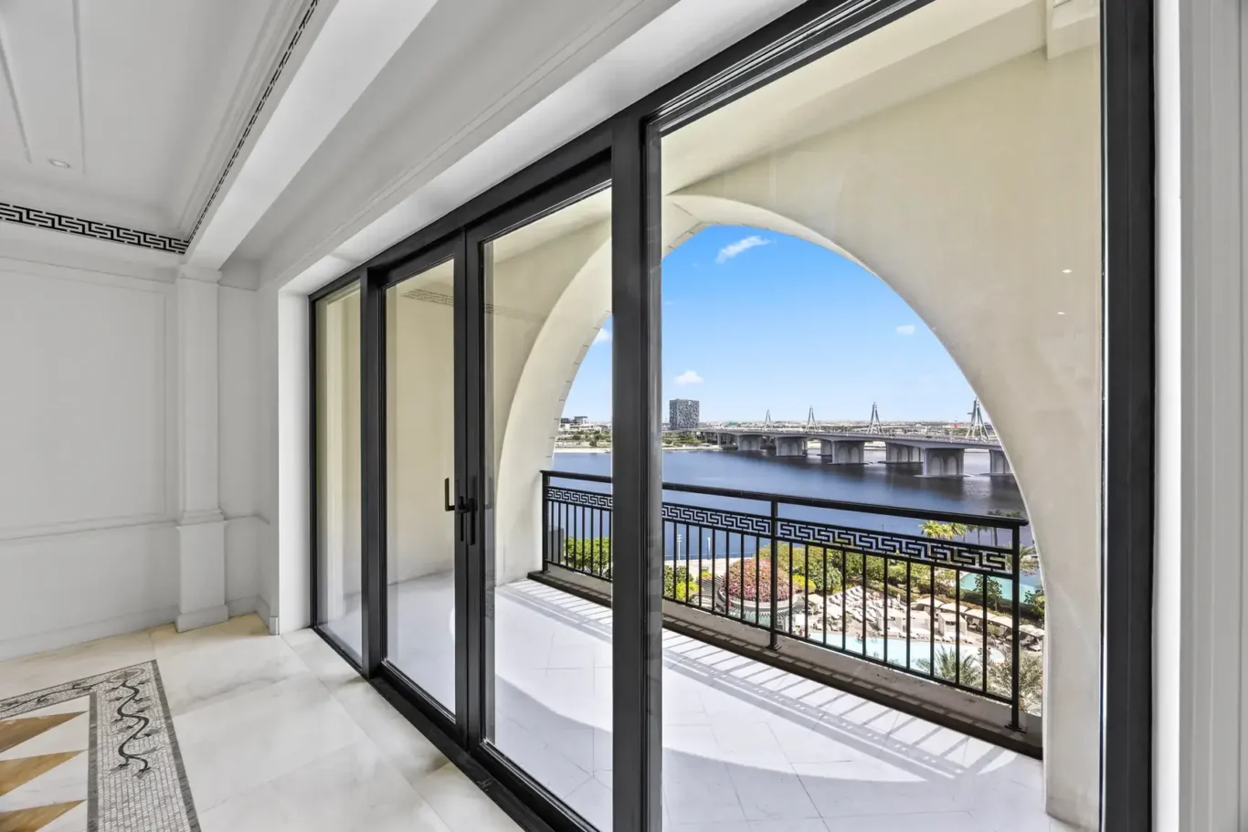 Living room opening onto an arched balcony with Dubai Creek view in a three-bedroom residence at Palazzo Versace Dubai, Jaddaf Waterfront, photographed for Concierge Auctions.