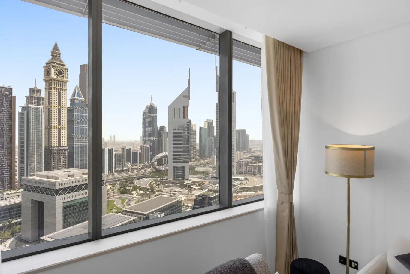 Living room with floor-to-ceiling windows over the DIFC skyline in a Your Stay Apartments one-bedroom at Sky Gardens, DIFC, Dubai.