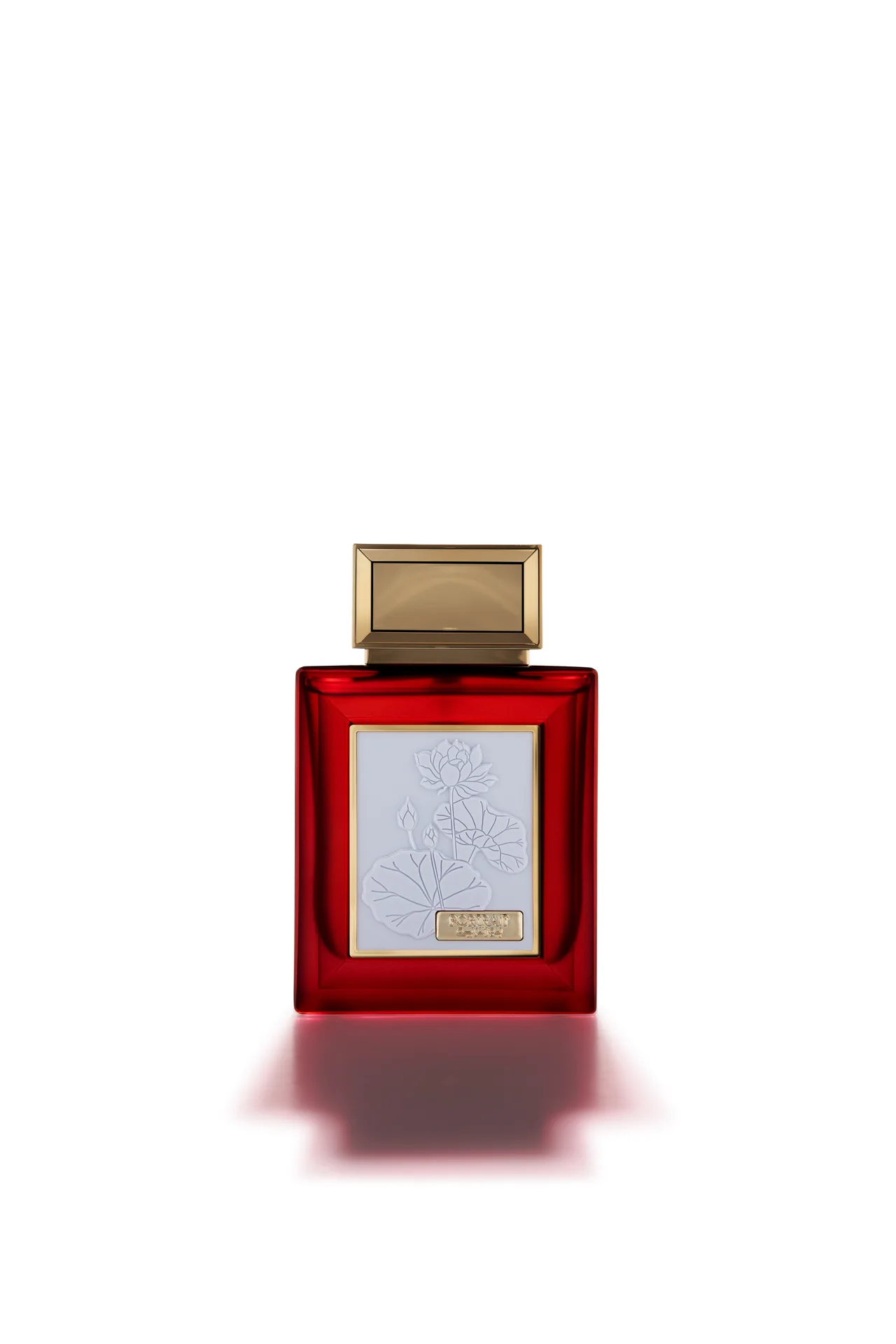 Oud Elite Portrait perfume in a red glass bottle with a gold cap and white embossed lotus label, photographed front-on against white.