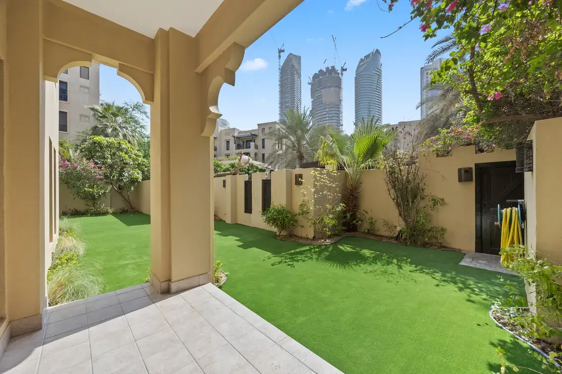 Arched terrace opening onto the private garden in an unfurnished two-bedroom garden apartment in Old Town, Downtown Dubai, photographed for ELITE Property Brokerage.