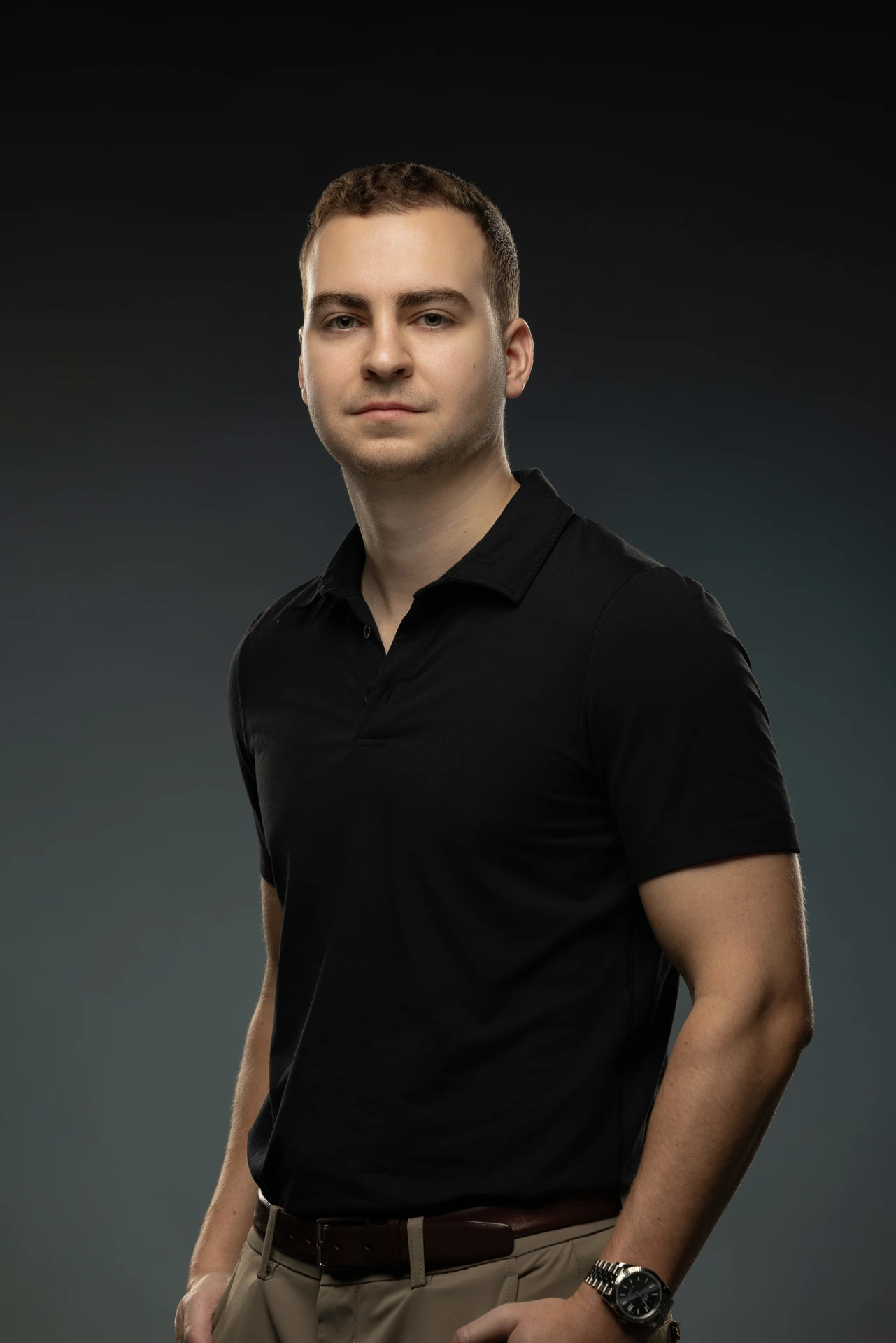 Confident half-body portrait in a black polo shirt. Professional headshot of Tim Ruscica of Tech With Tim, photographed at the MRPS studio in Dubai.