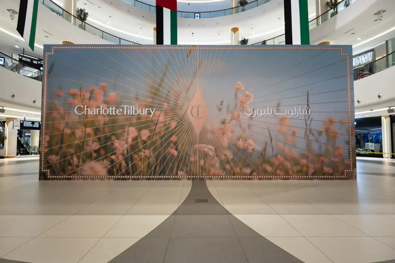 Front view of the finished Hoarding by Lomax hoarding for a Charlotte Tilbury pop-up at The Dubai Mall, with English and Arabic branding.